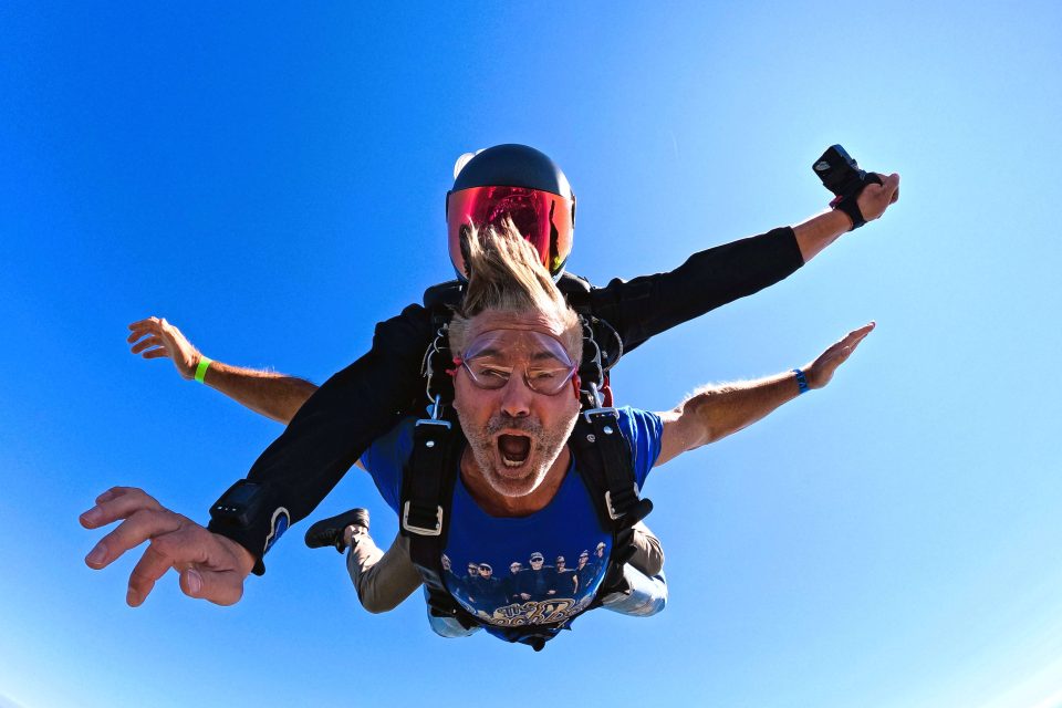 Tandem skydiving above the New York coastline.