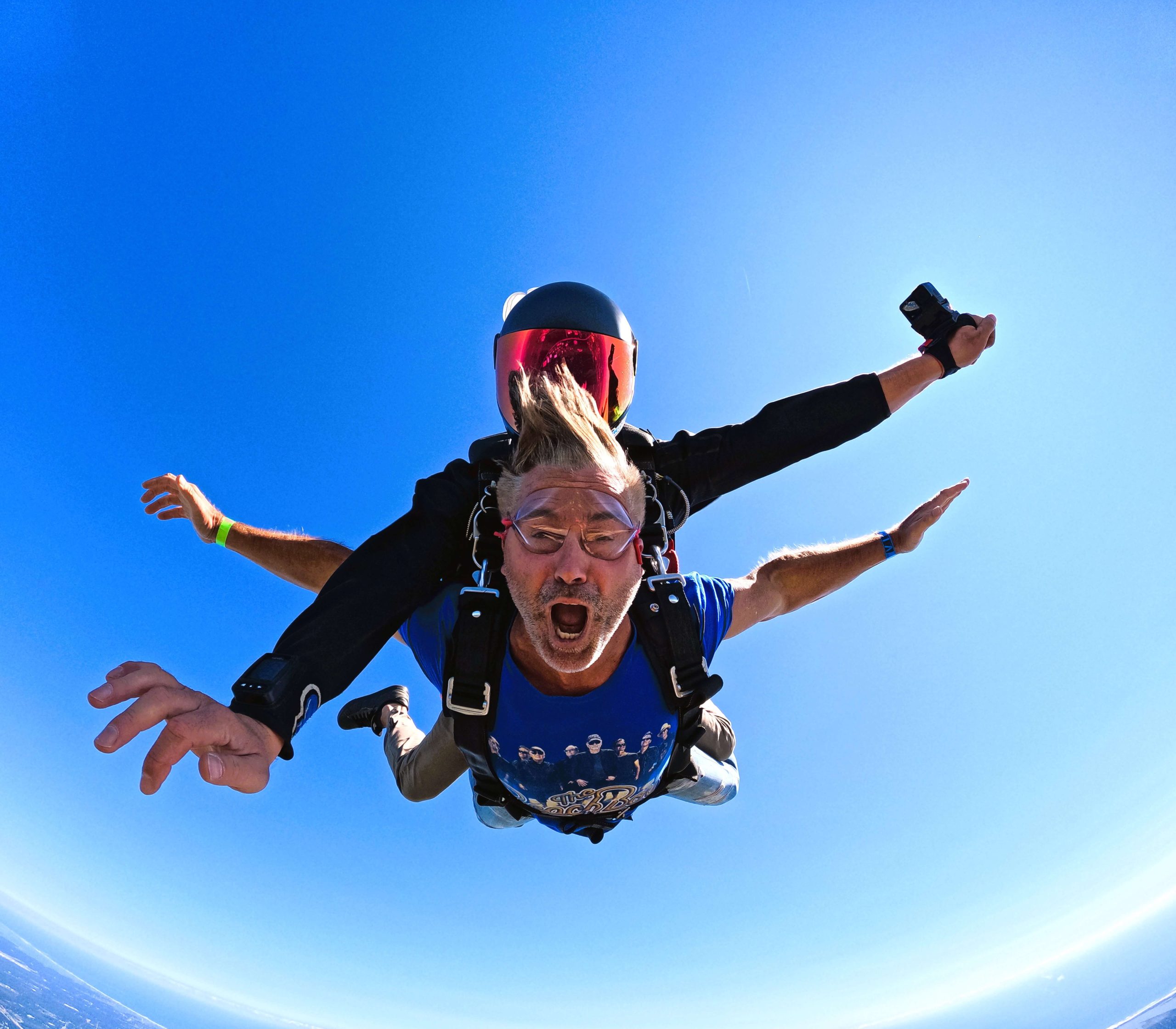 Tandem skydiving above the New York coastline.