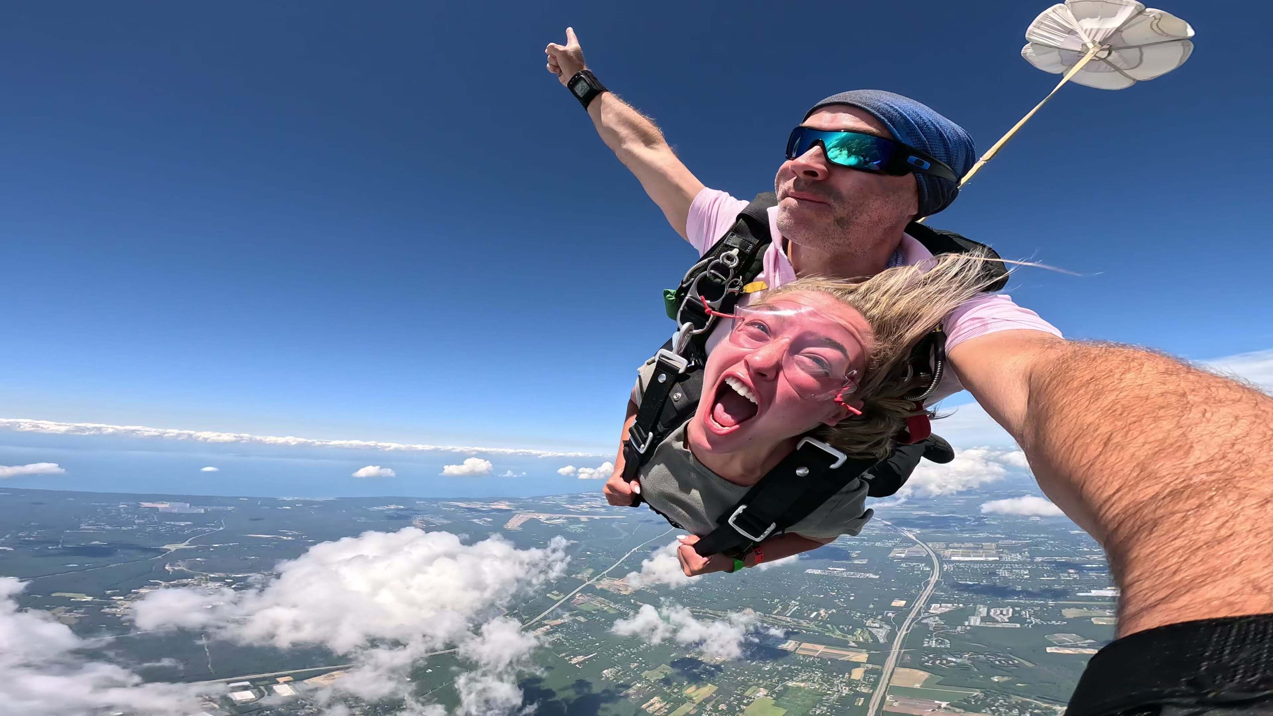 Happy girl skydiving by the New York coastline