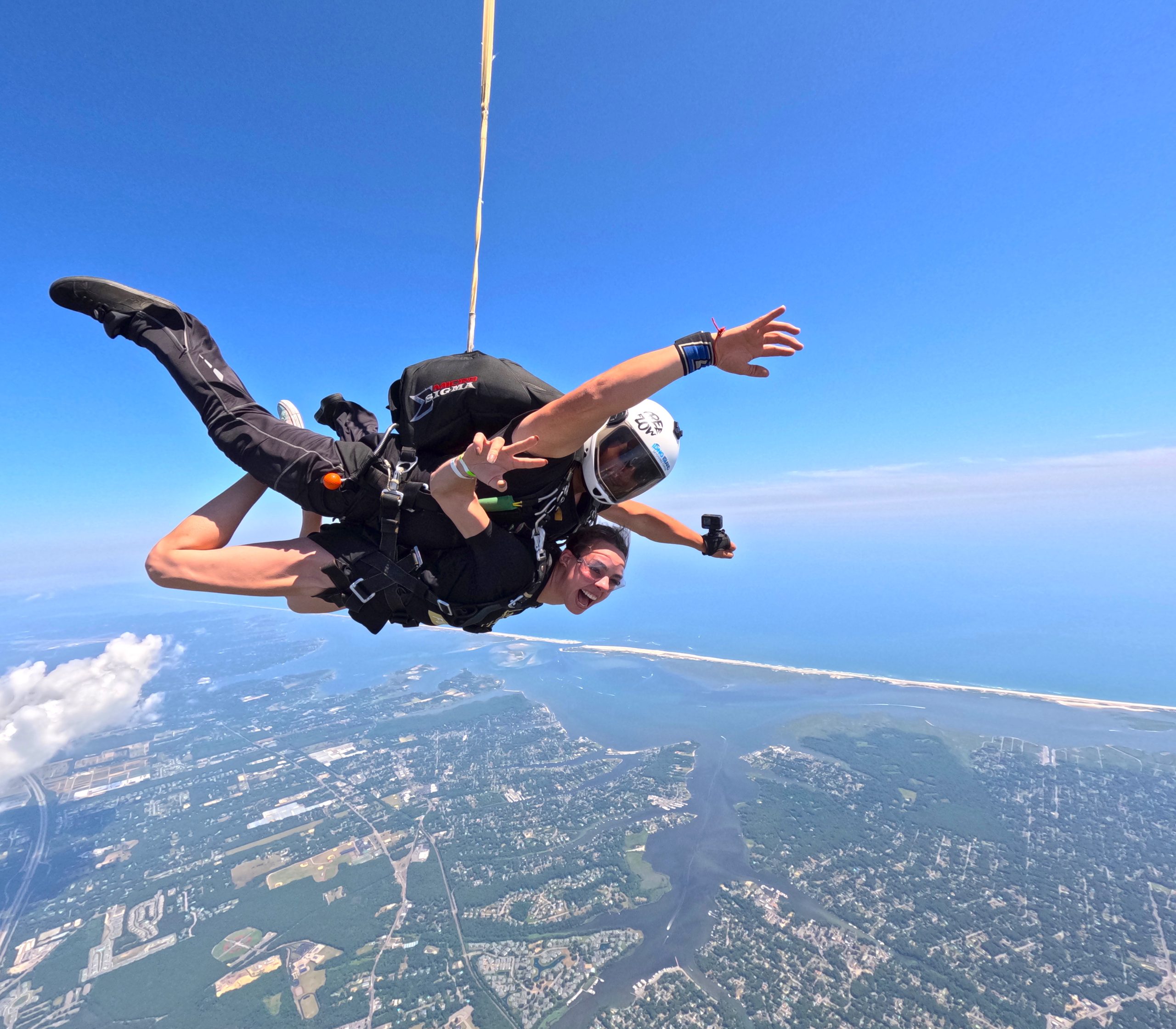 woman attached to tandem skydiving instructor freefalling over Long Island